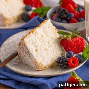 Feather-Light Angel Food Dream 15 Angel food cake slice served with fresh berries, showcasing its delicate texture.