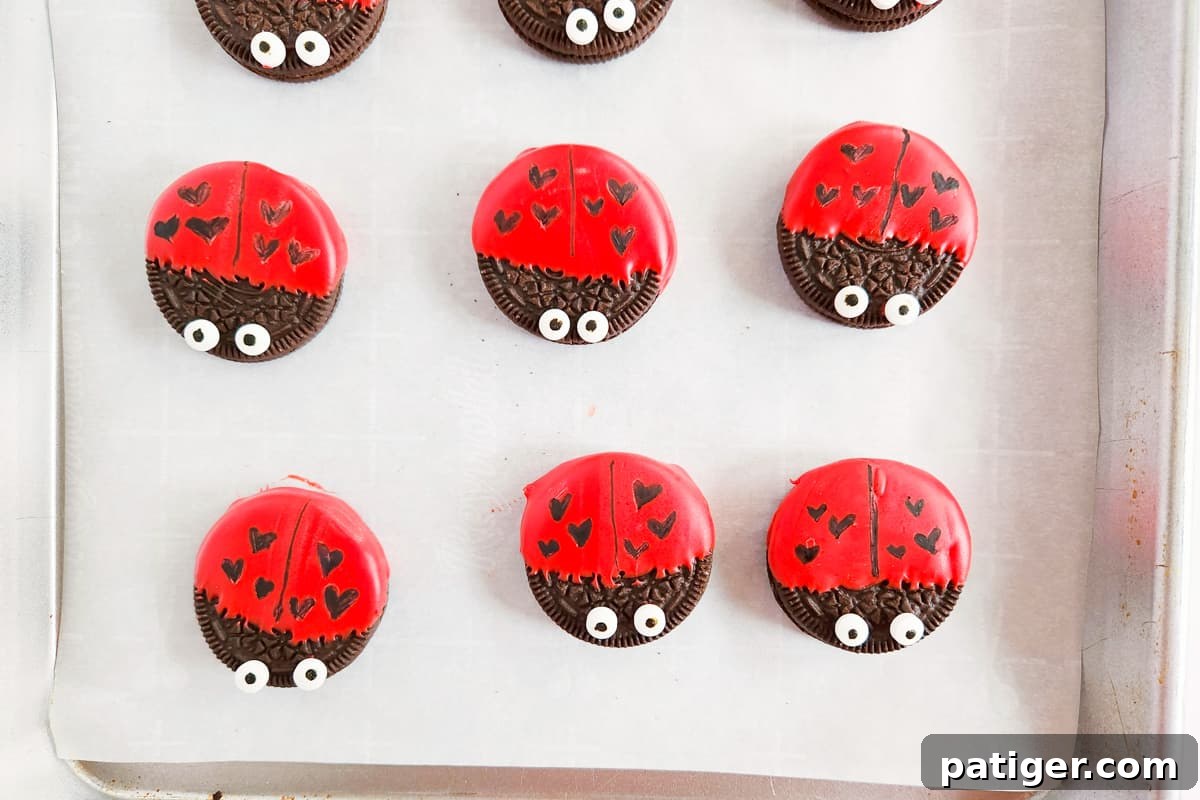 Black line added down the center of the red portion of the cookie and three hearts drawn on either side.