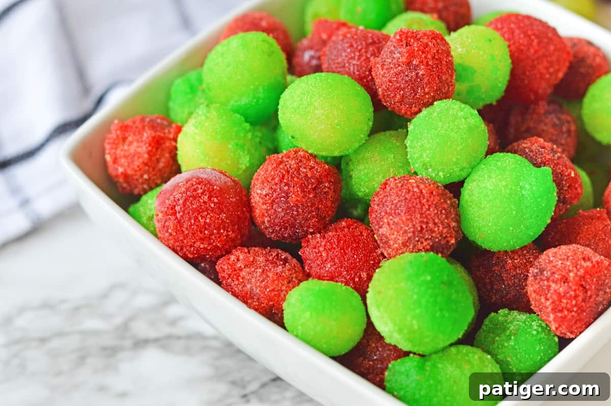 Close up of red and green frozen jello grapes.
