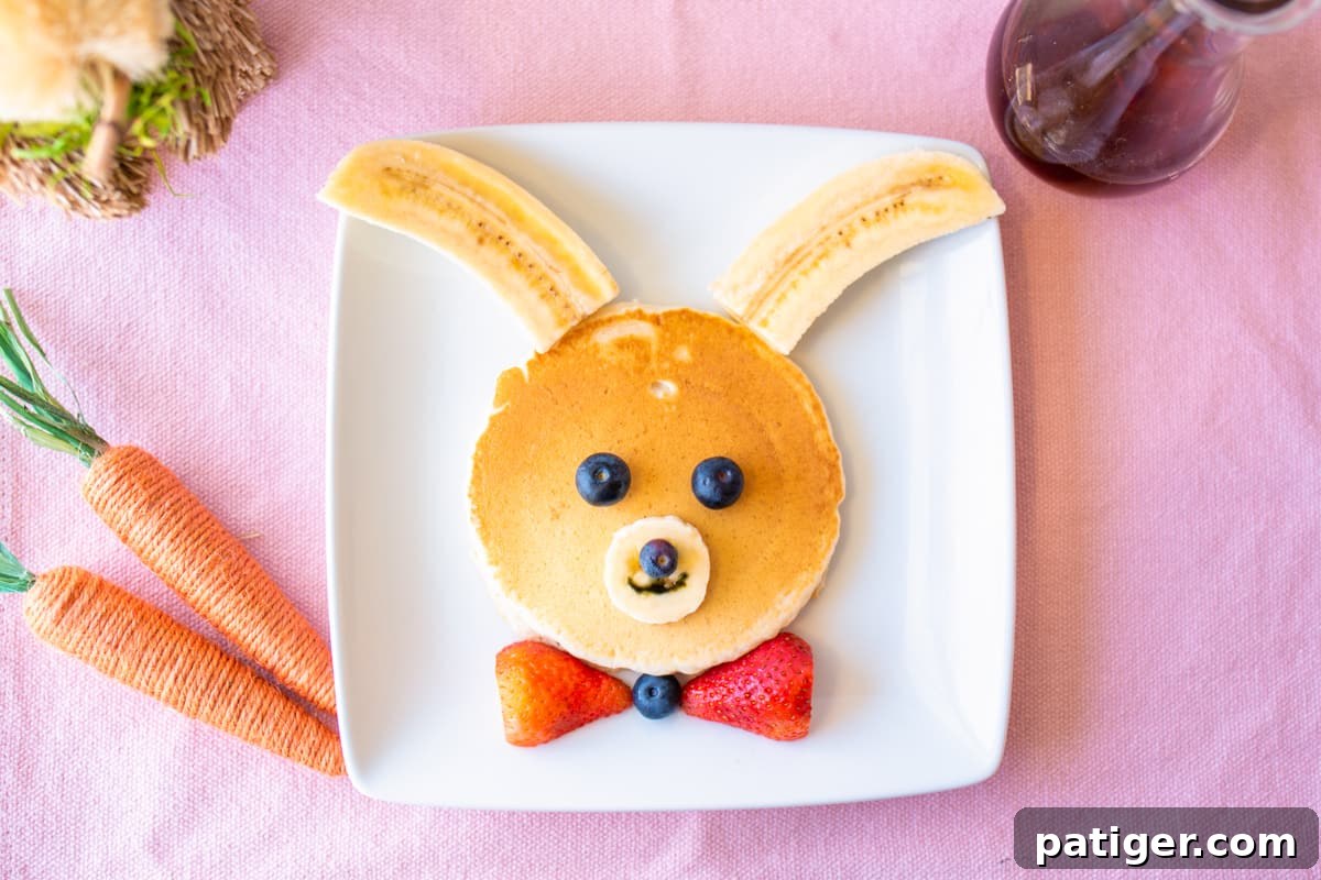 Bunny pancakes decorated with bananas and berries, a delightful Easter breakfast idea.