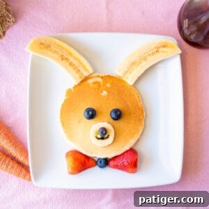 Bunny pancakes decorated with bananas and berries.