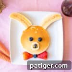 Bunny pancakes decorated with bananas and berries.