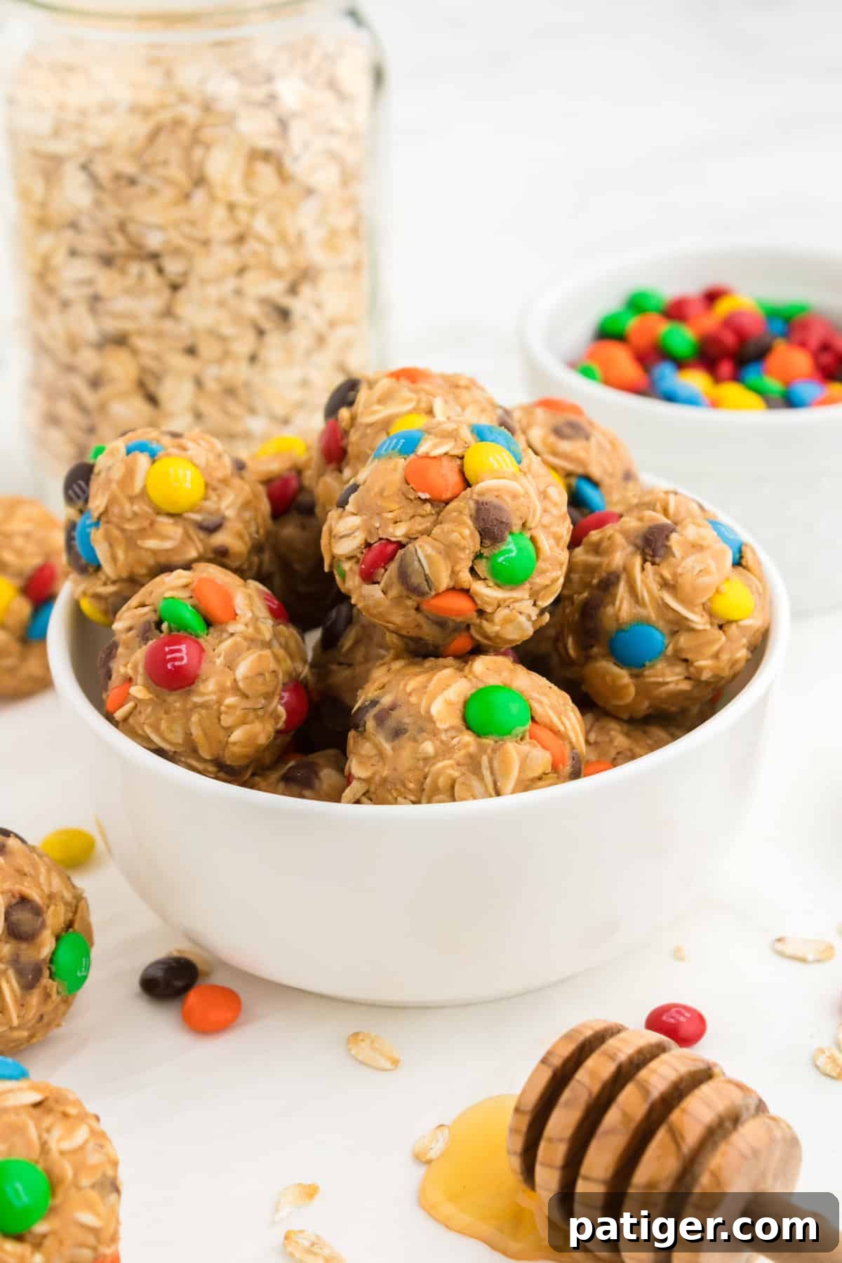 No-Bake Monster Cookie Energy Bites 2 Monster Energy Balls made with oats, mini M&Ms, chocolate chips, peanut butter, and honey.