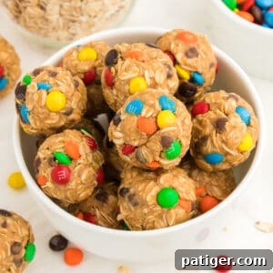 No-Bake Monster Cookie Energy Bites 11 Monster Energy Balls with oats, mini M&Ms, chocolate chips, peanut butter, and honey.