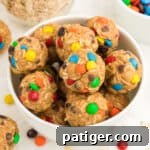 No-Bake Monster Cookie Energy Bites 12 Monster Energy Balls with oats, mini M&Ms, chocolate chips, peanut butter, and honey.