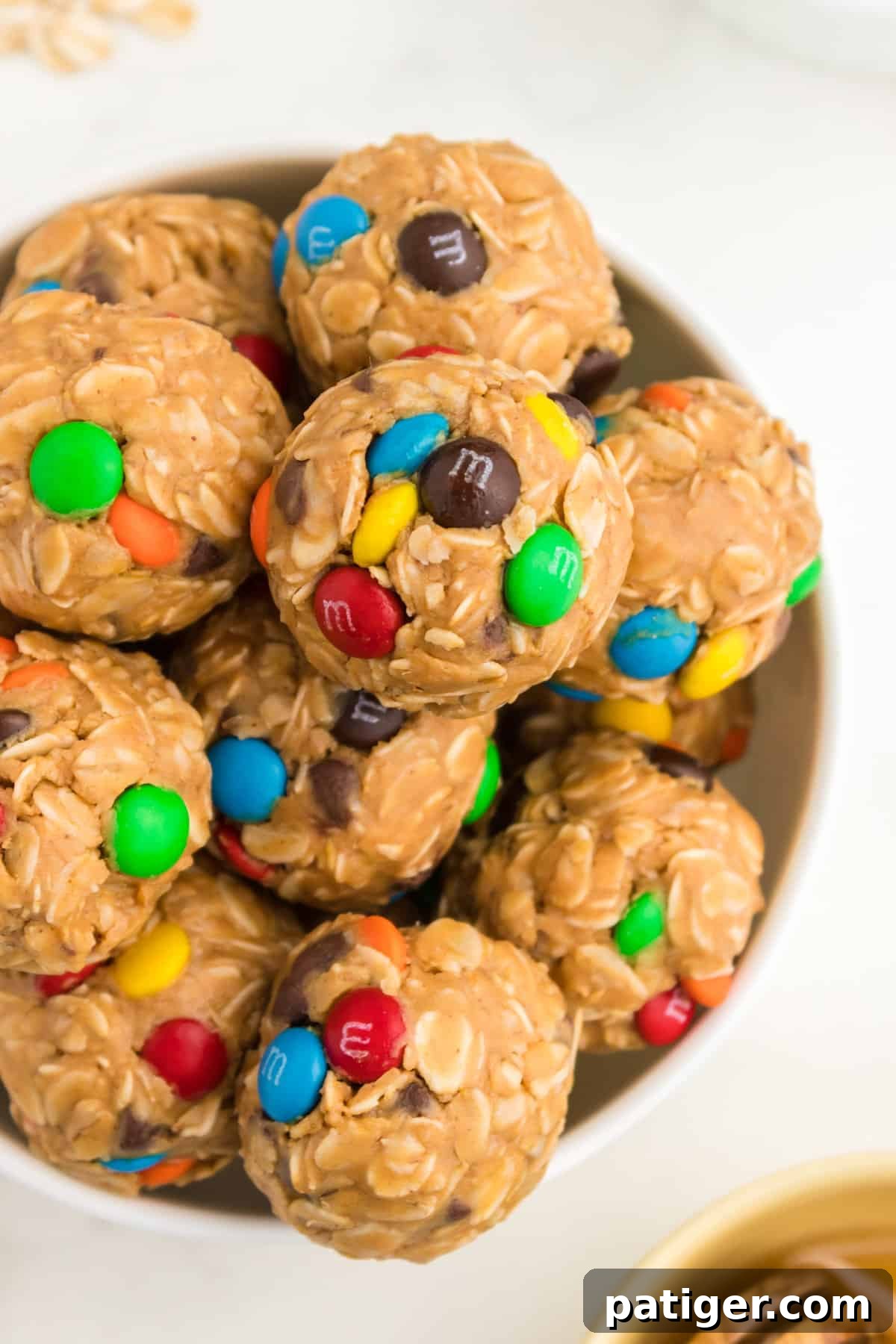 No-Bake Monster Cookie Energy Bites 3 Bowl of no-bake energy balls with oats, chocolate chips, and M&Ms.