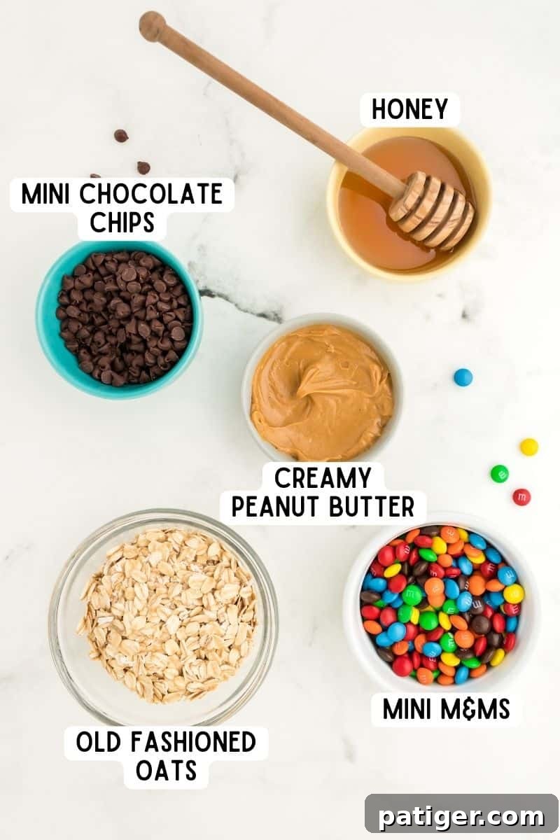 No-Bake Monster Cookie Energy Bites 4 Ingredients in bowls: honey, creamy peanut butter, mini chocolate chips, mini M&Ms, and old-fashioned oats.