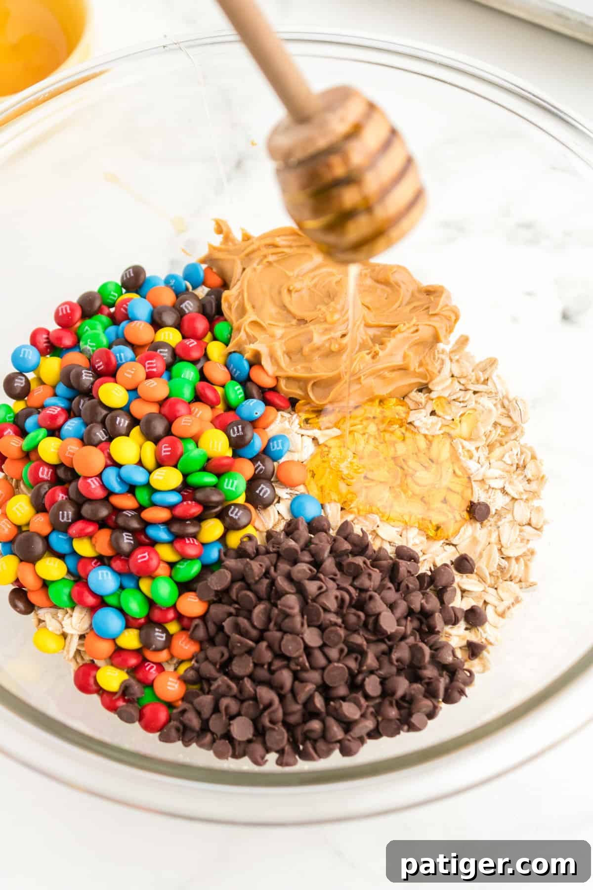 No-Bake Monster Cookie Energy Bites 5 All ingredients in a glass mixing bowl.