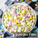 Easter muddy buddies chex mix in a white serving bowl.