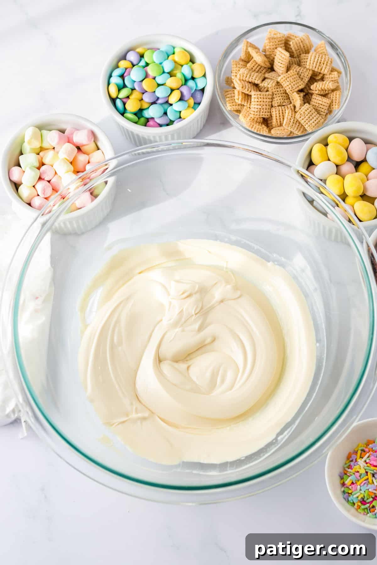Melted almond bark in large glass bowl.