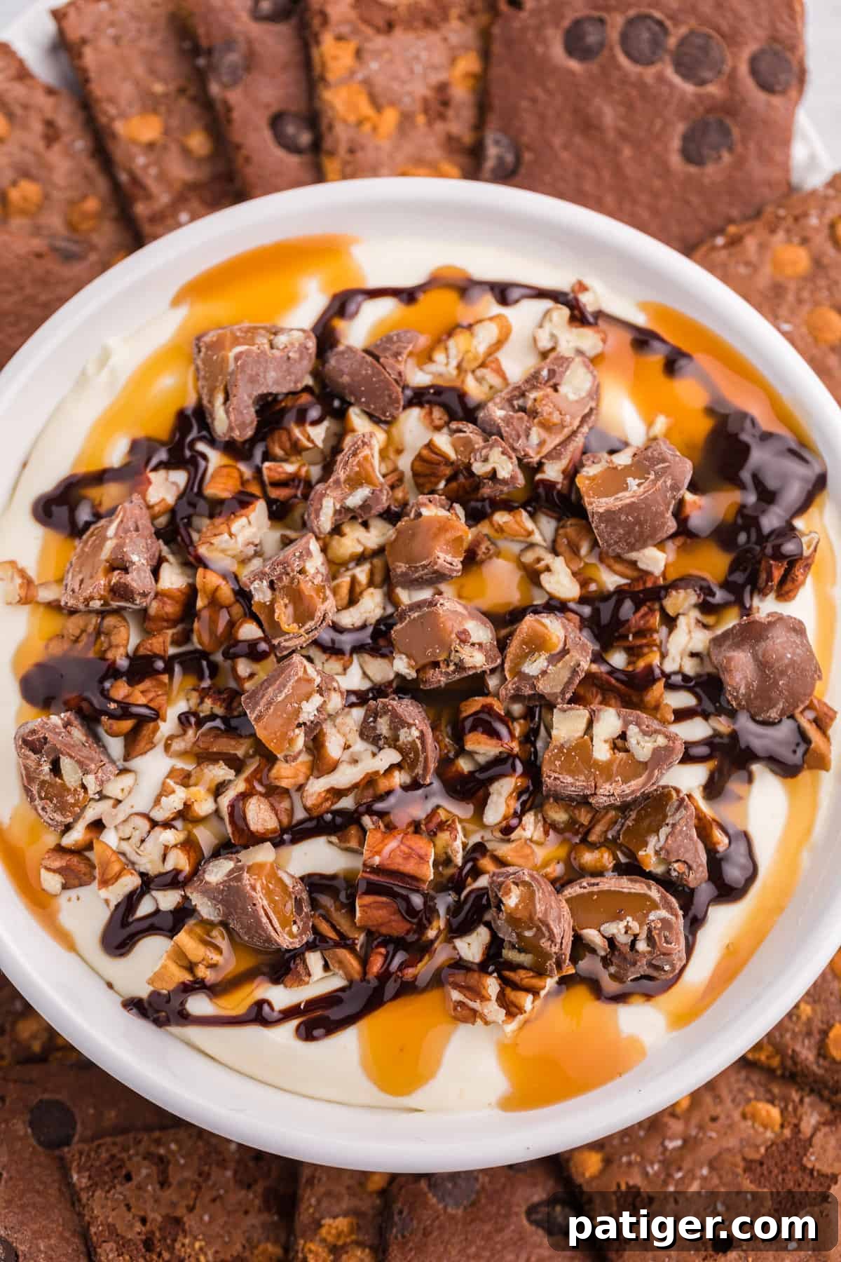 Overhead view of Turtle dip in serving bowl surrounded by brownie brittle dippers.