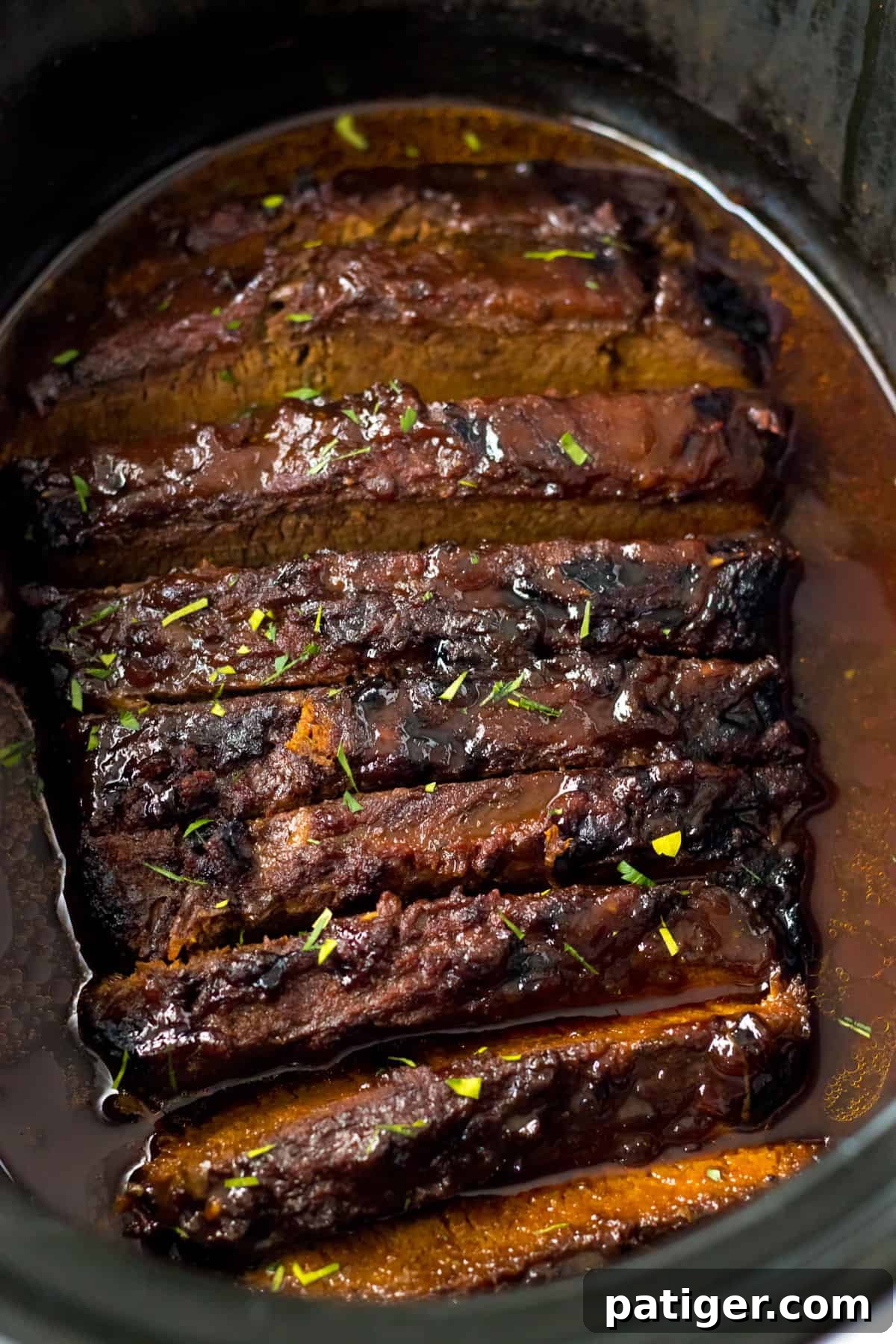 Slow cooker brisket with bbq sauce and seasonings.