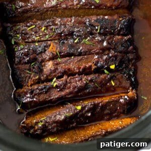 Slow cooker brisket with bbq sauce and seasonings.