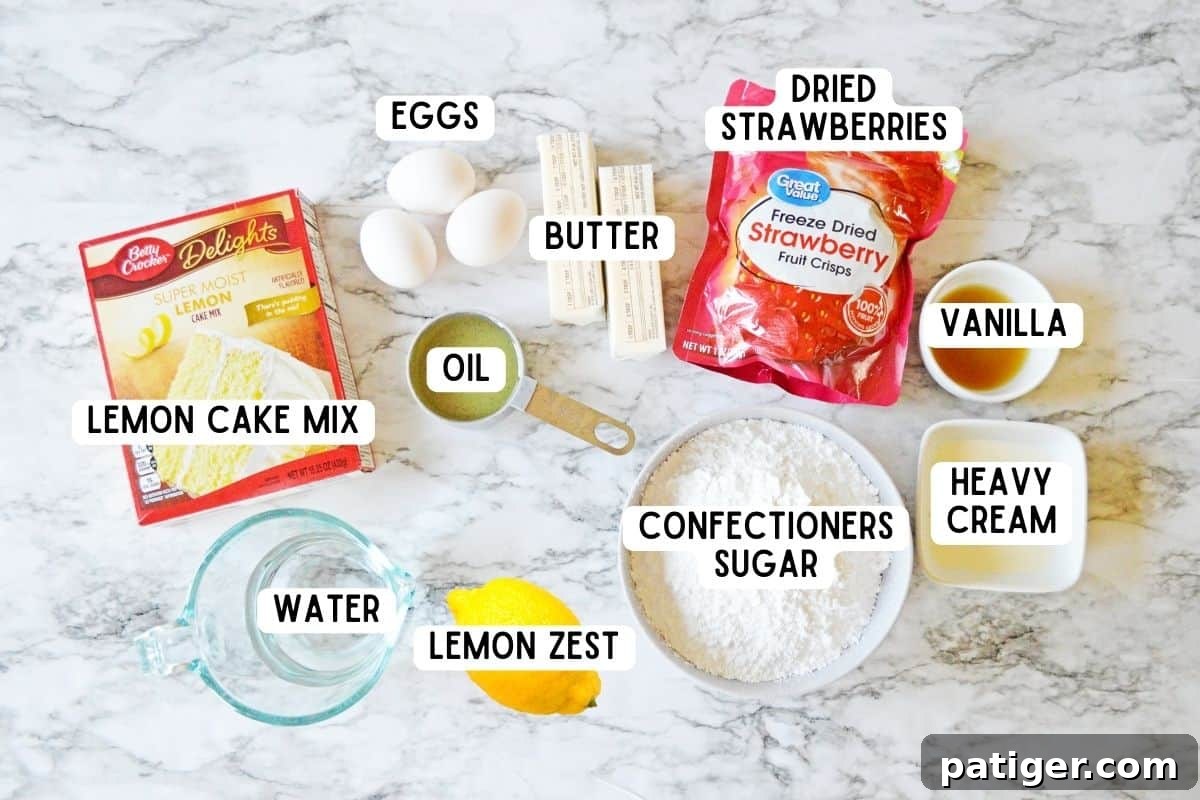 Pink Lemonade Swirl Cupcakes 4 A collection of ingredients for strawberry lemonade cupcakes: lemon cake mix, eggs, butter, freeze-dried strawberries, confectioners sugar, lemon, vanilla extract, oil, and heavy cream, neatly arranged.