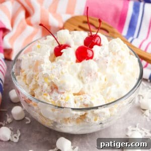 Marshmallow fruit salad with cherries in a large bowl.