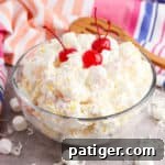 Marshmallow fruit salad with cherries in a large bowl.