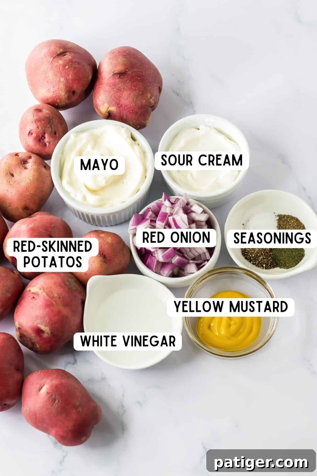 Red potatoes, mayo, sour cream, red onion, yellow mustard, white vinegar, and seasonings.