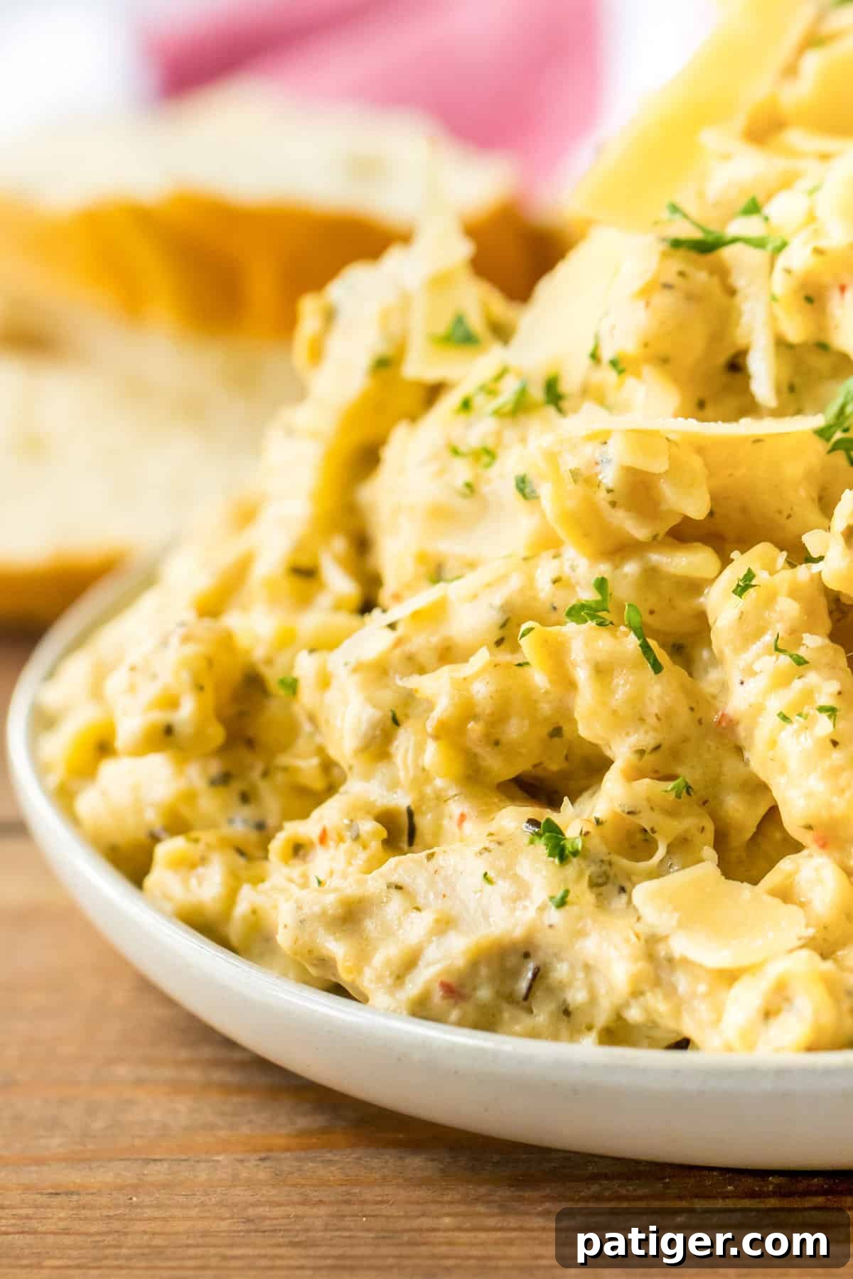 Creamy Crockpot Garlic Parmesan Chicken Pasta 7 Creamy crockpot buffalo wild wings garlic parmesan chicken pasta served on a white plate.