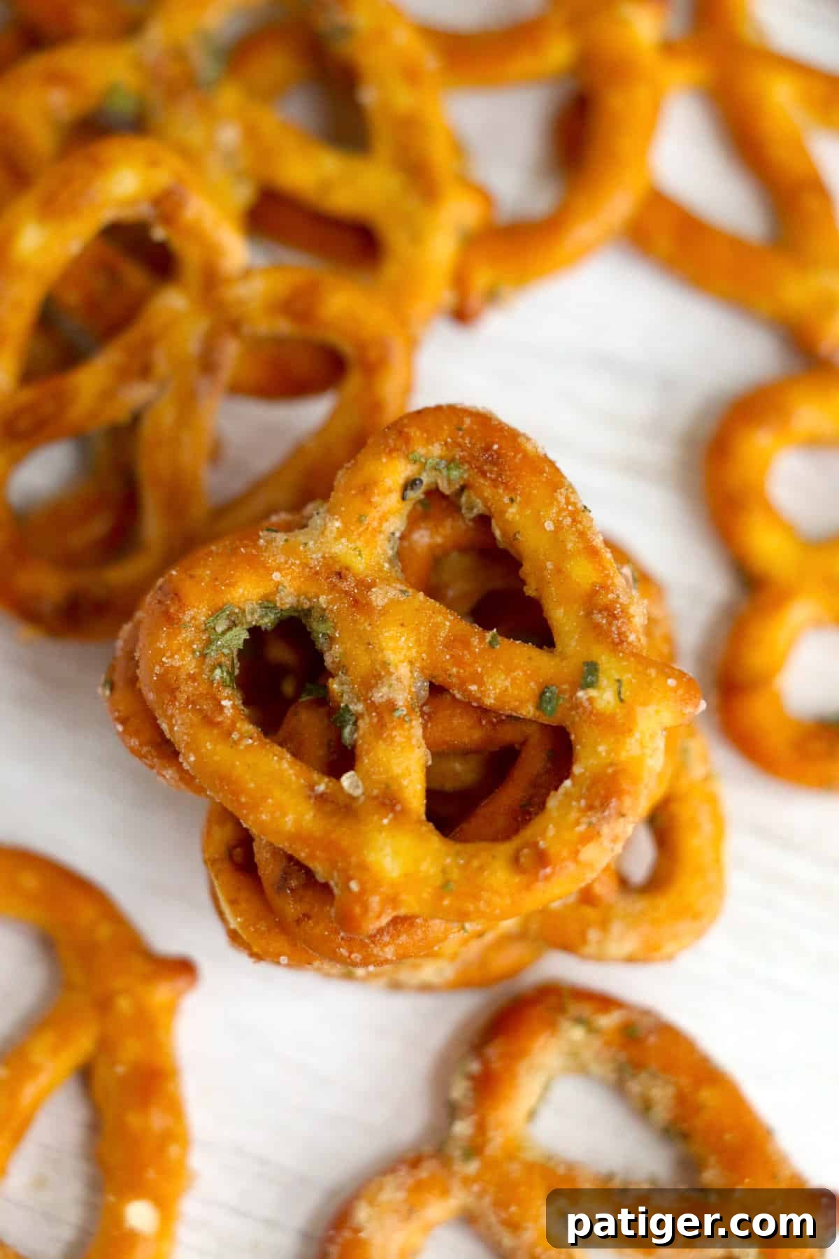 A scattering of ranch and garlic seasoned pretzels on a table, ready for a party or snack time.
