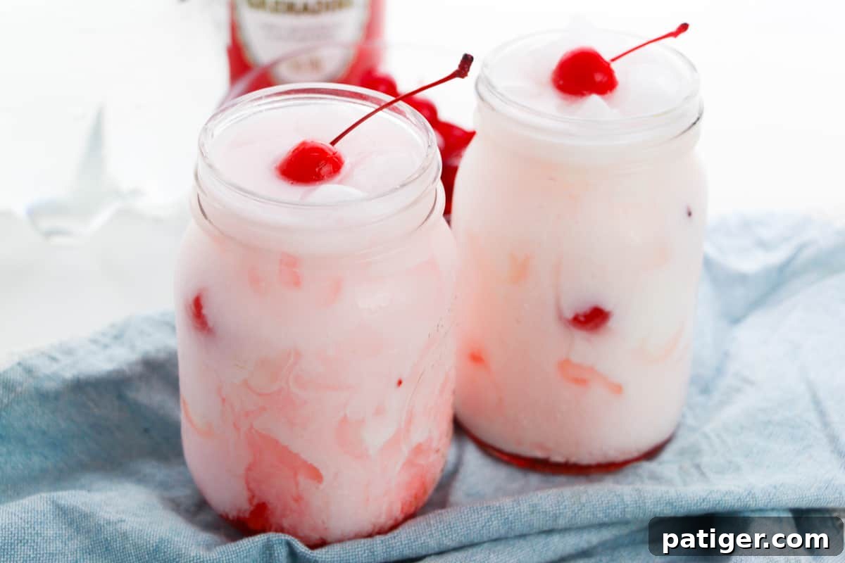 Shirley Temple Cream Soda 6 Shirley temple dirty sodas garnished with cherries in two mason jars.