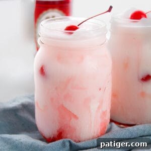Shirley temple dirty soda with Sprite, grenadine, creamer, and maraschino cherry.