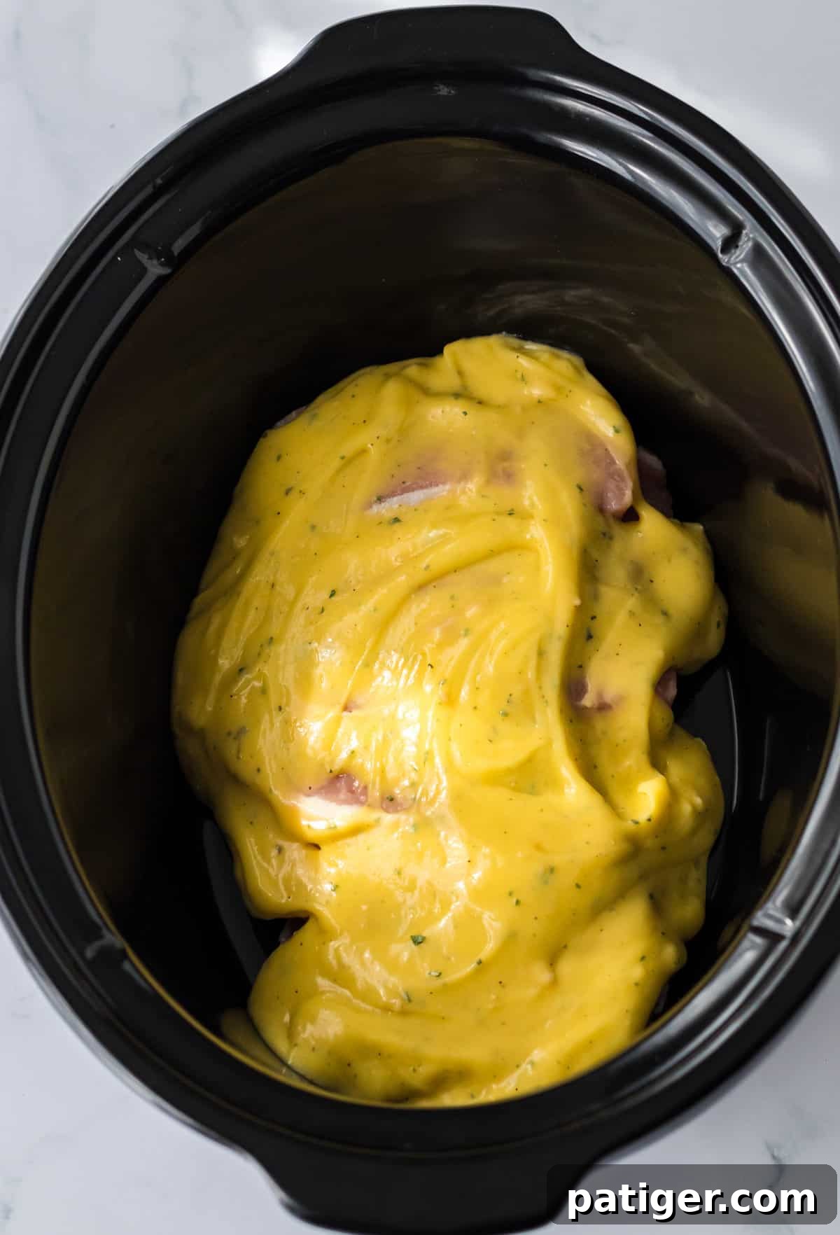 Melt-in-Your-Mouth Slow Cooker Ranch Pork Chops 5 Cream of chicken soup on top of pork chops in crock pot.