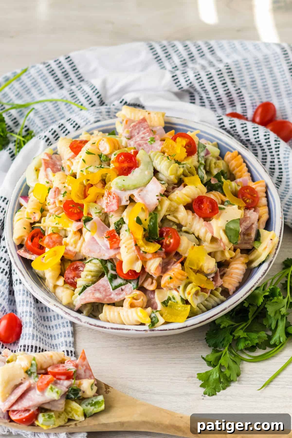 Italian Hoagie Pasta Salad 2 Italian sub pasta salad featuring tri-color rotini, a medley of deli meats, fresh vegetables, and cheese, served in a large bowl.
