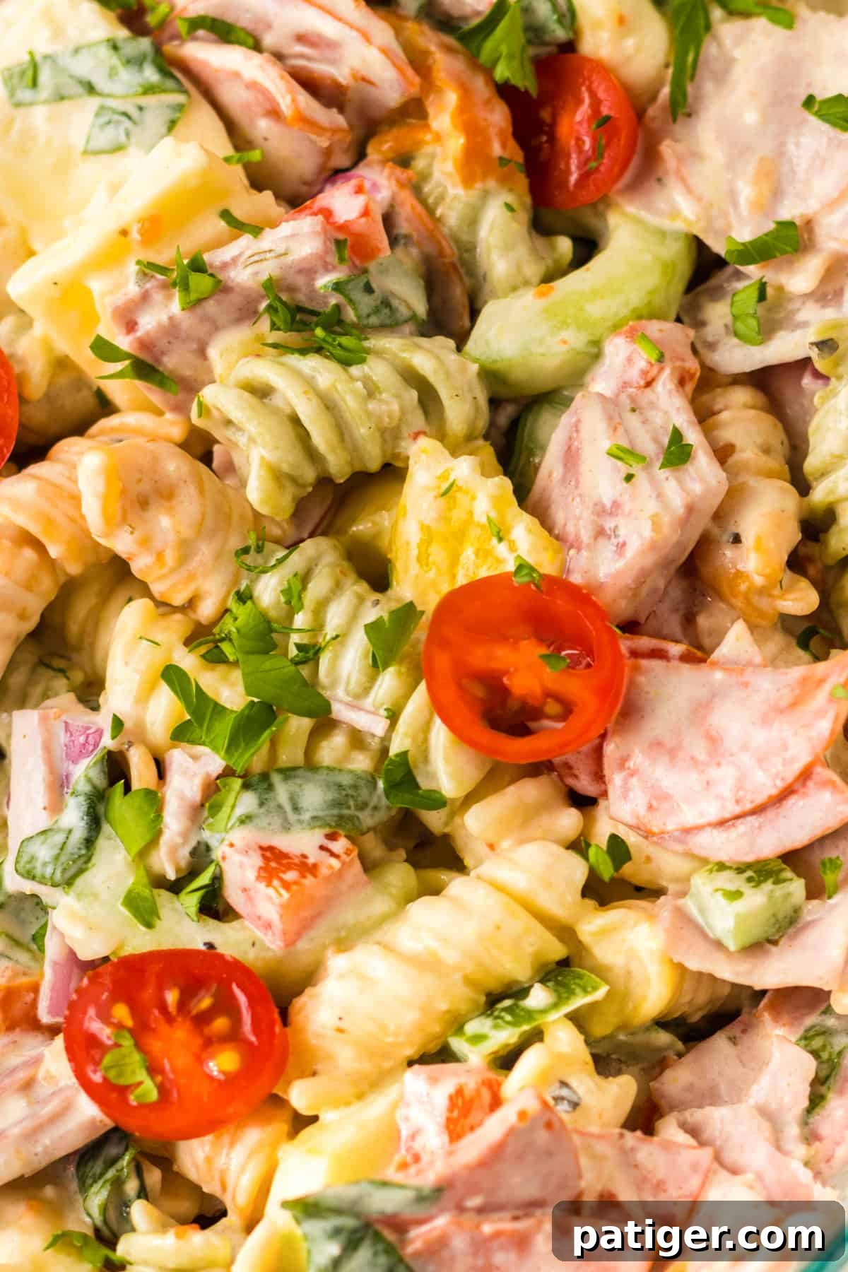 Italian Hoagie Pasta Salad 3 Italian hoagie pasta salad presented in a glass bowl, showcasing a mix of cold cuts, colorful vegetables, and rotini pasta.