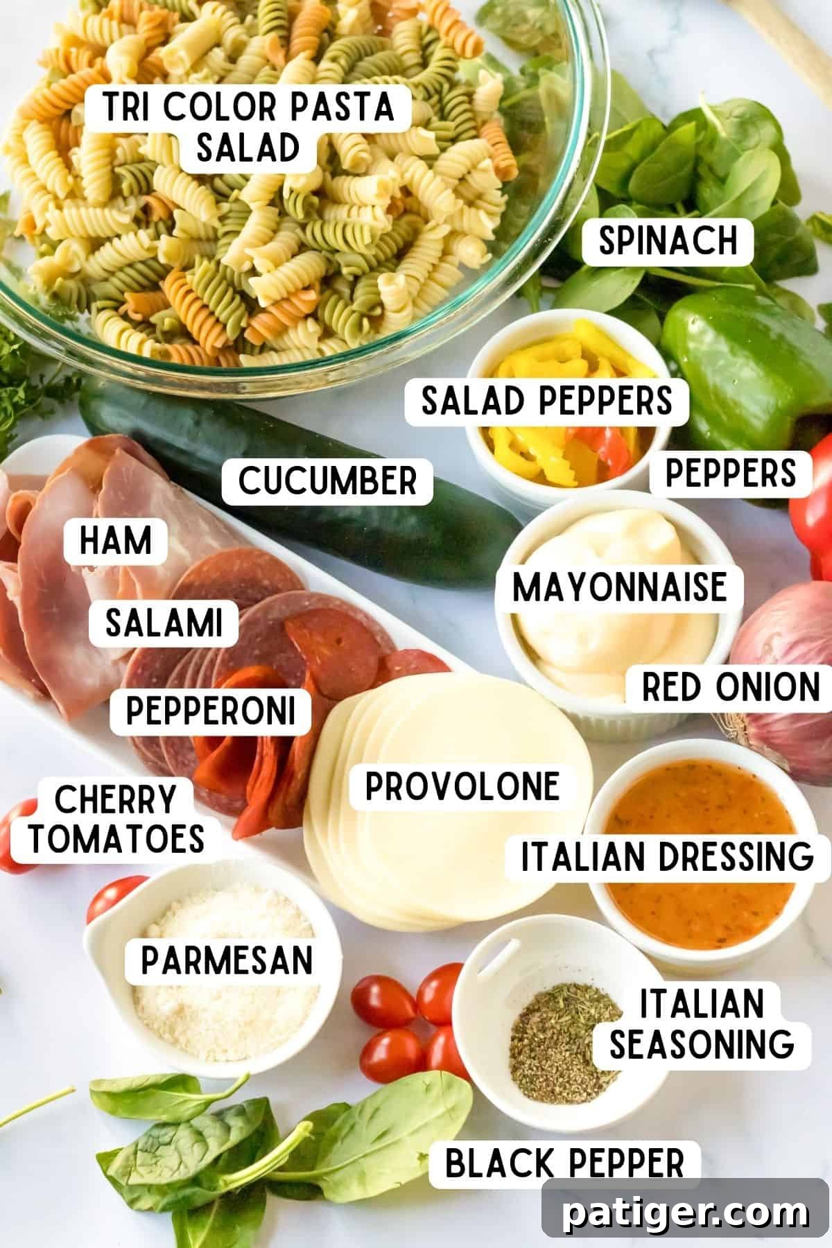 Italian Hoagie Pasta Salad 4 An array of Italian pasta salad ingredients: tri-color rotini, vibrant red and green bell peppers, tangy salad peppers, slices of ham, salami, pepperoni, fresh spinach, creamy mayonnaise, zesty Italian dressing, delicate sliced provolone, rich grated parmesan, aromatic black pepper, robust Italian seasoning, sharp red onion, refreshing cucumber, and sweet cherry tomatoes.