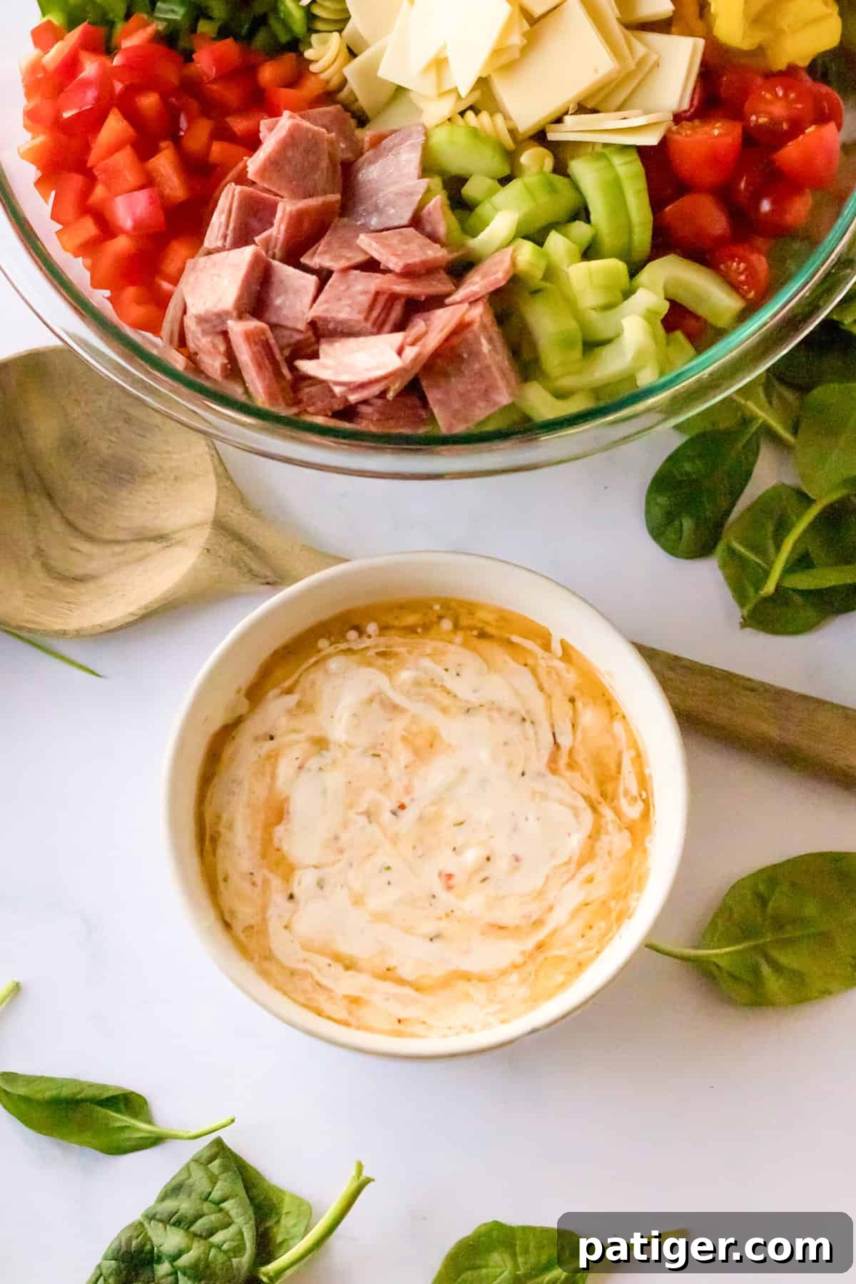 Italian Hoagie Pasta Salad 6 A small bowl holding a perfectly blended, creamy Italian salad dressing, rich in texture and ready to enhance the pasta salad.
