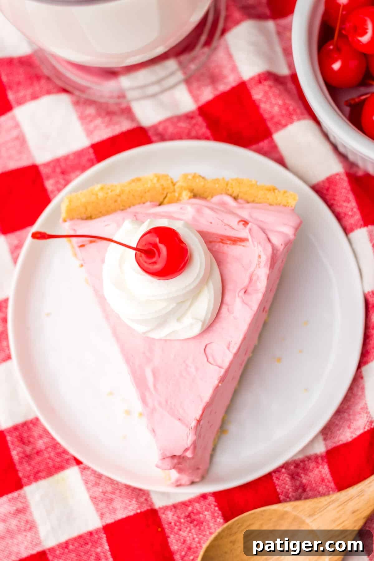 Summer Sip Pie 11 An inviting overhead view of a single slice of colorful, 4-ingredient no-bake Kool-Aid pie on a white plate.