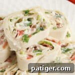 Ranch BLT Pinwheels made with flour tortillas, bacon, lettuce, tomatoes, and ranch dressing stacked on a white plate. A small version of the main recipe image.
