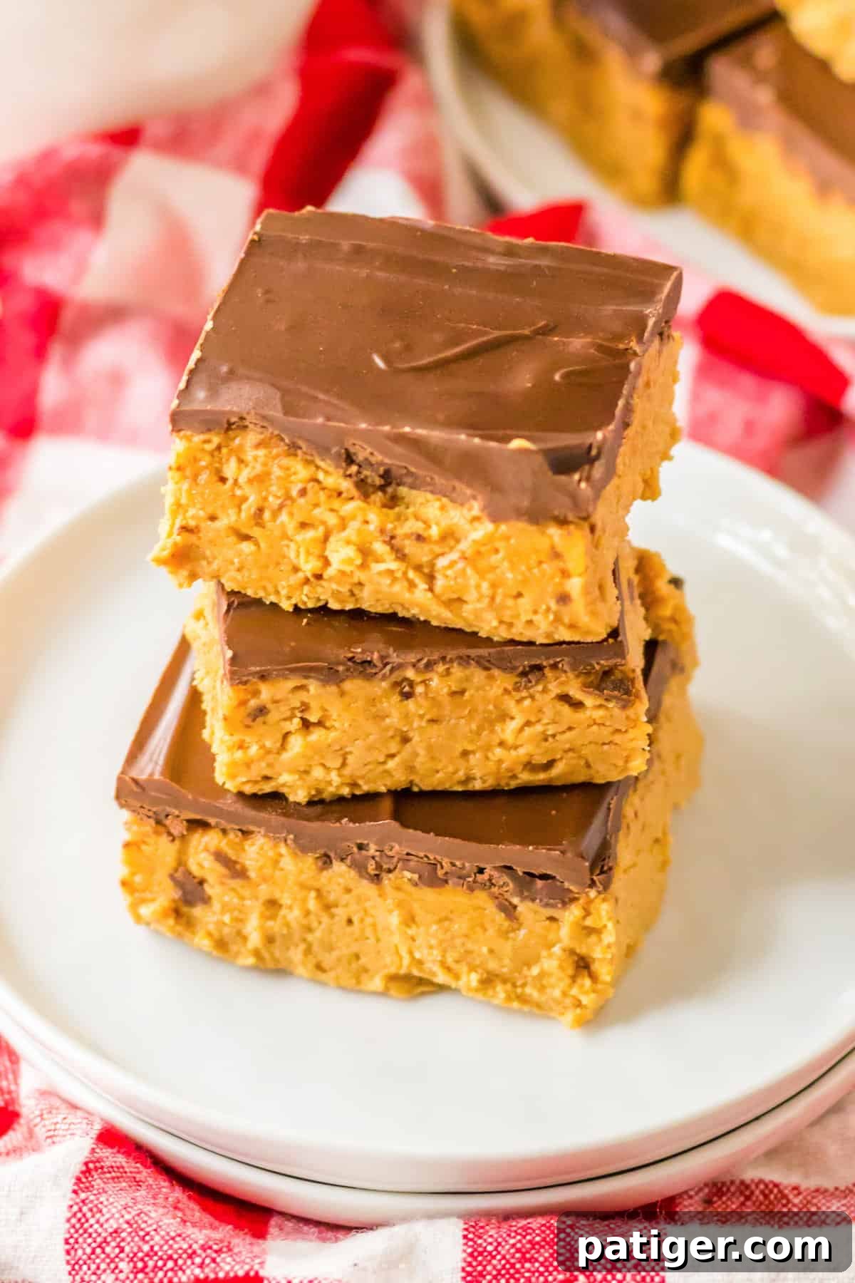 Chilled Chocolate Peanut Butter Fudge Squares 7 Three easy no-bake peanut butter bars topped with a thin layer of chocolate, ready to be served.