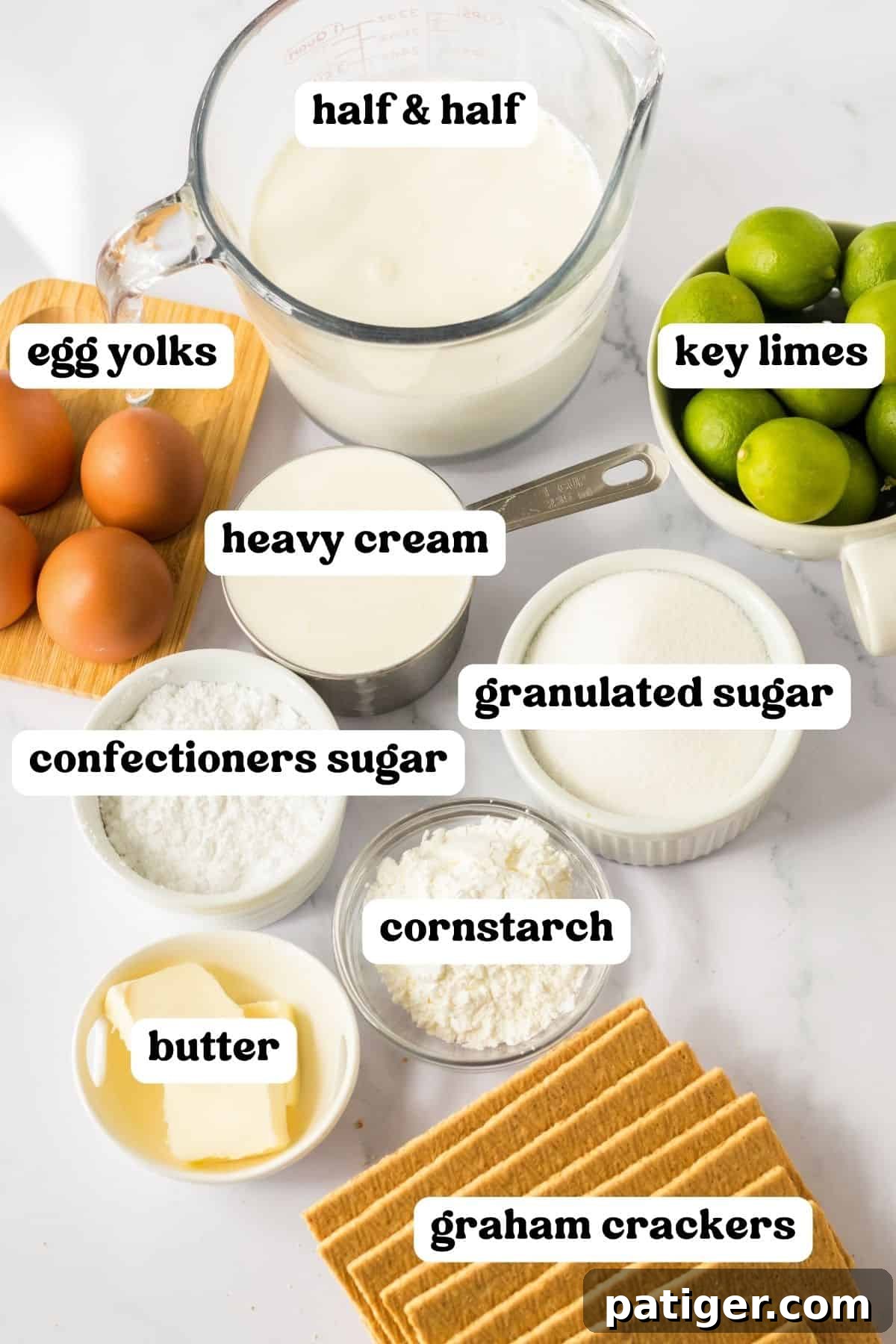 Ingredients for Key Lime Pudding Cake laid out on a countertop, showcasing fresh key limes, graham crackers, and dairy.