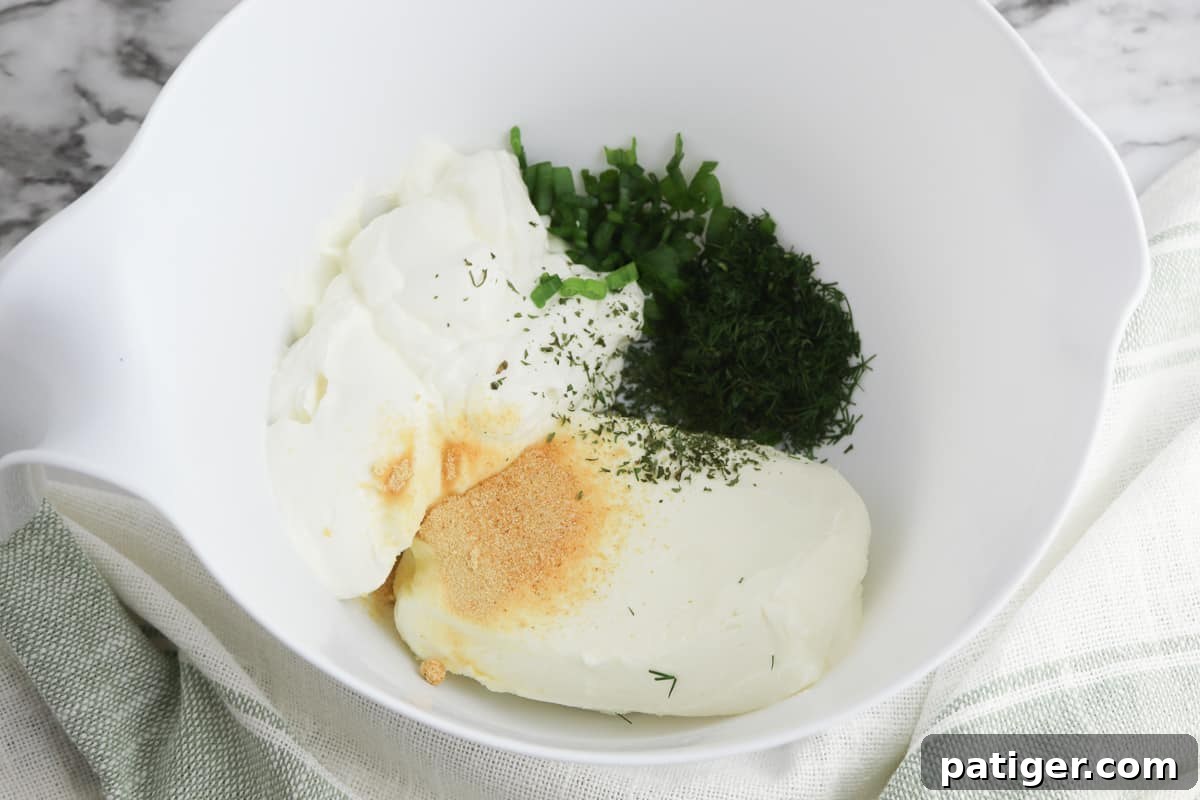 Zesty Dill Cream Cheese Dip 4 Dill dip ingredients all in a mixing bowl.