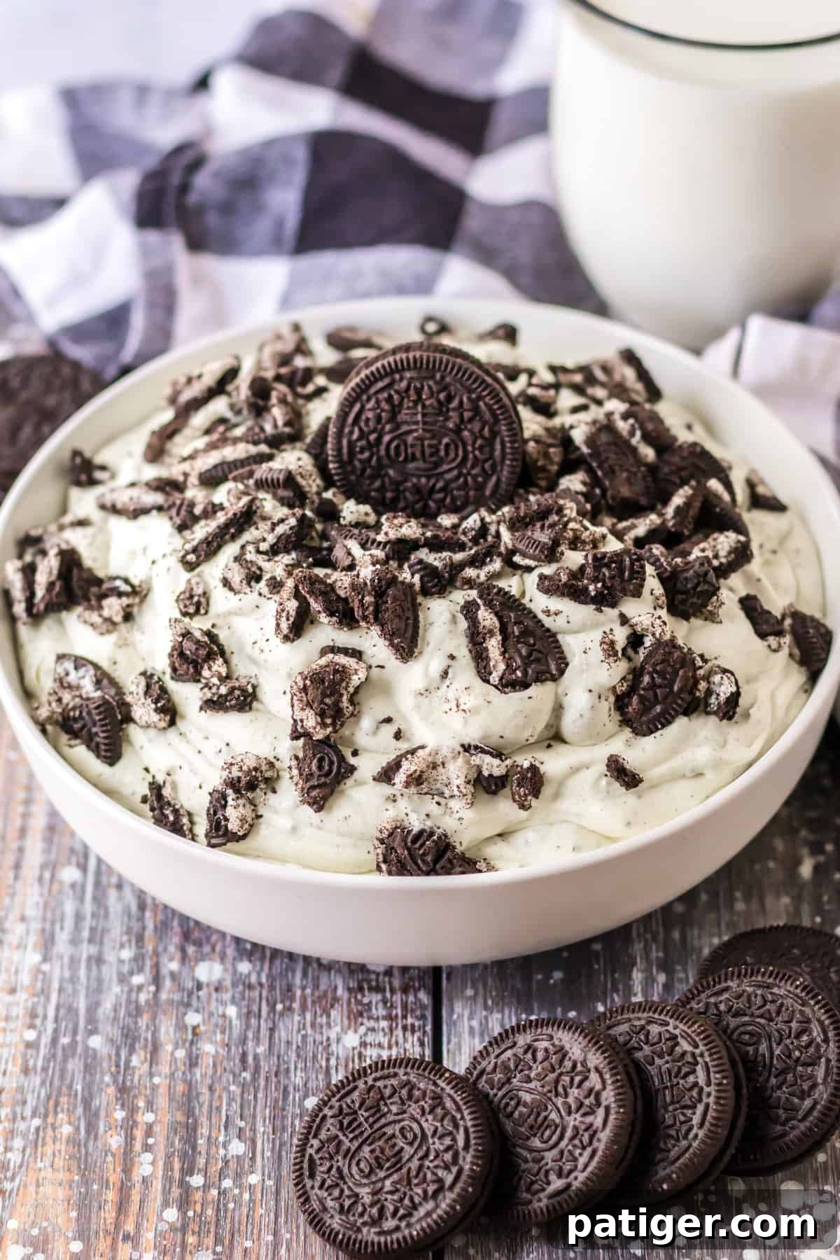 Creamy Oreo Fluff dessert made with vanilla pudding, cool whip, crushed Oreo cookies, and milk, ready to be served.