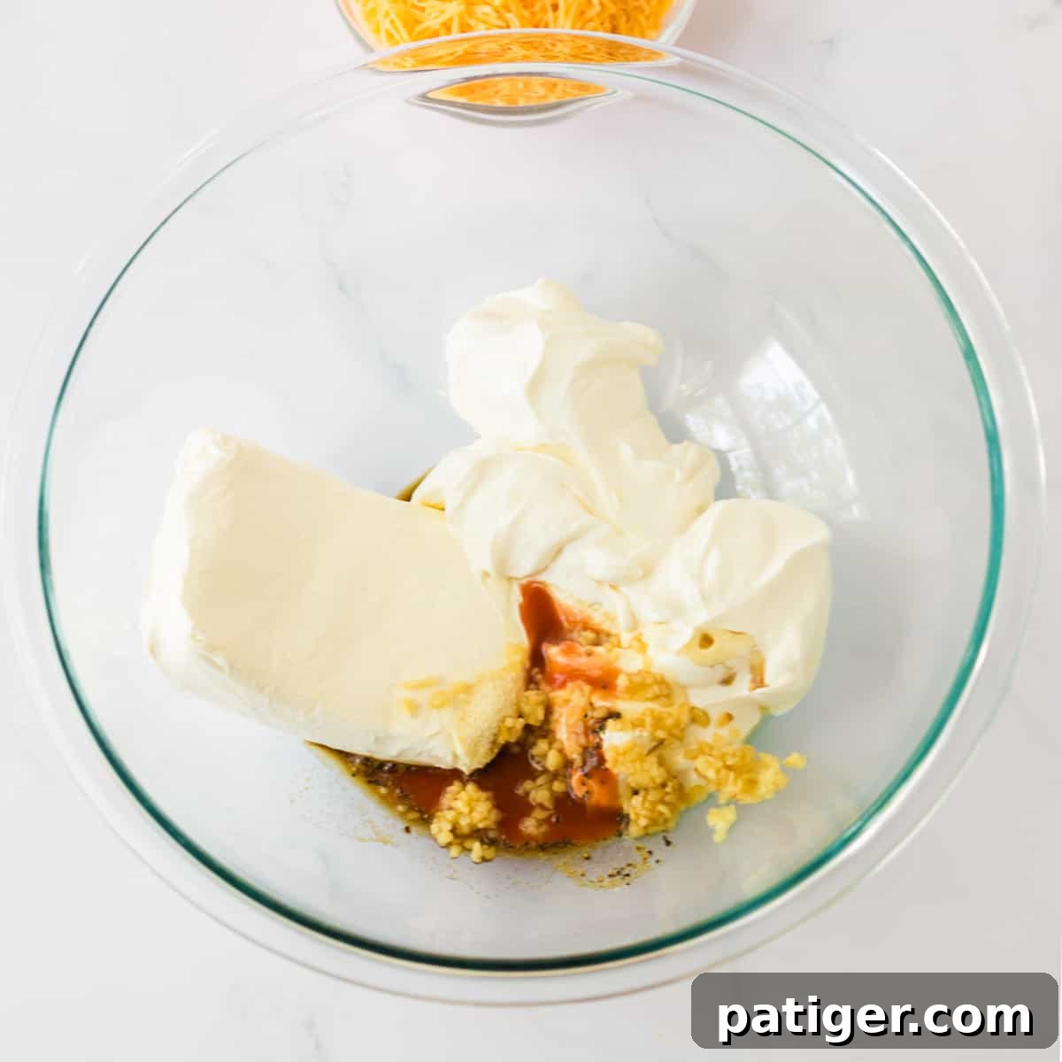 Cream cheese, sour cream, garlic, onion poweder, pepper, hot sauce. and Worcestershire sauce in a mixing bowl.