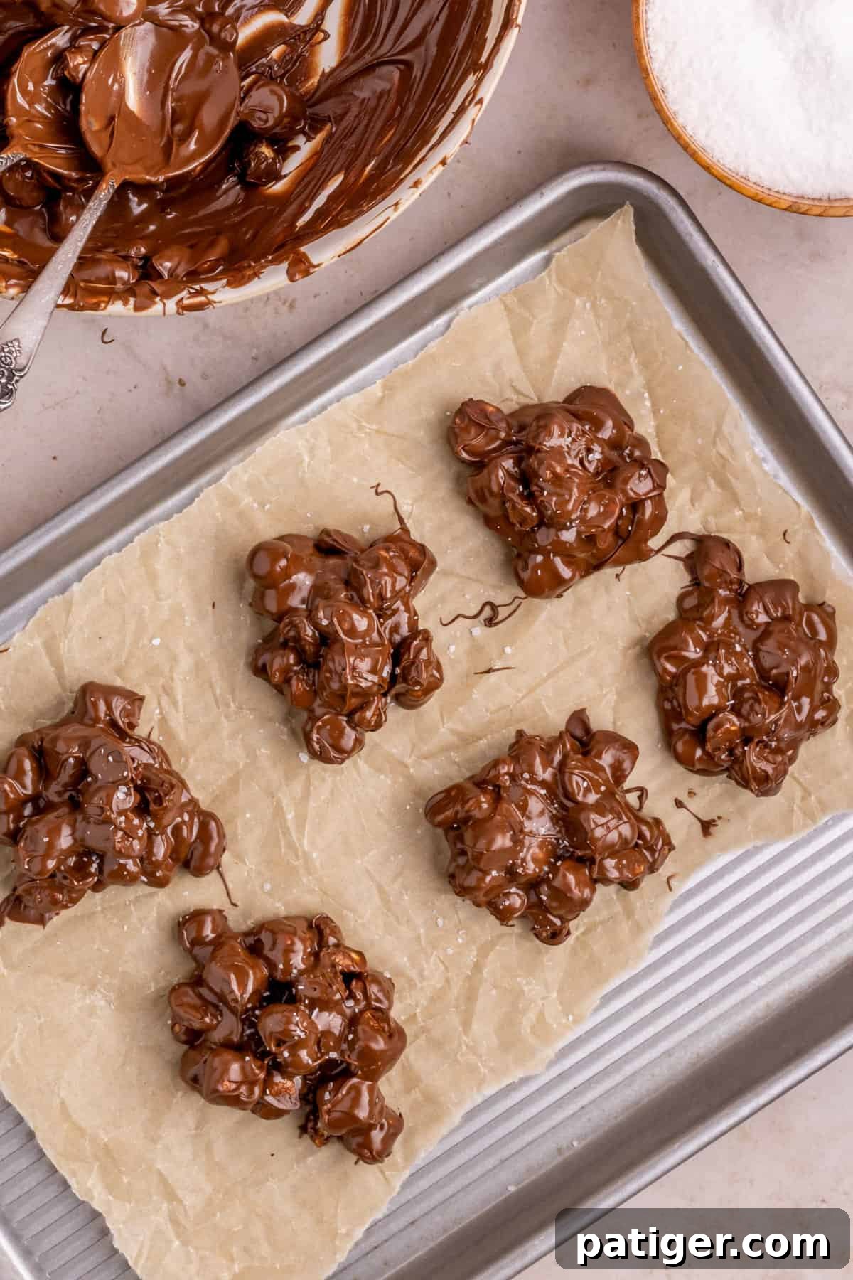 Rocky Road candy topped with salt on lined baking sheet.