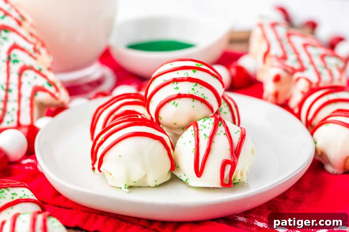 Little Debbie Christmas Tree Cake Balls arranged on a white plate, surrounded by whole Little Debbie Christmas Tree Cakes, creating a festive display.