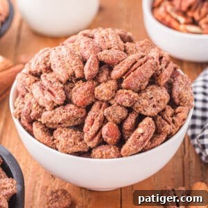 Candied pecans and almonds in a white bowl, ready for serving.