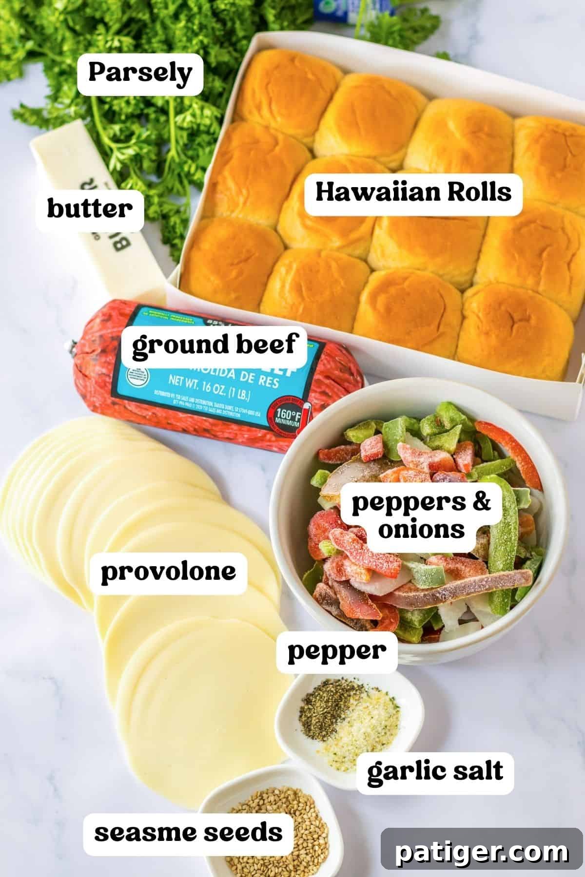 Gooey Philly Slider Perfection 4 Individual ingredients for cheesesteak sliders: Hawaiian Slider Rolls, ground beef, fresh parsley, a bag of frozen peppers and onion mix, slices of provolone cheese, sesame seeds, butter, garlic salt, and black pepper.