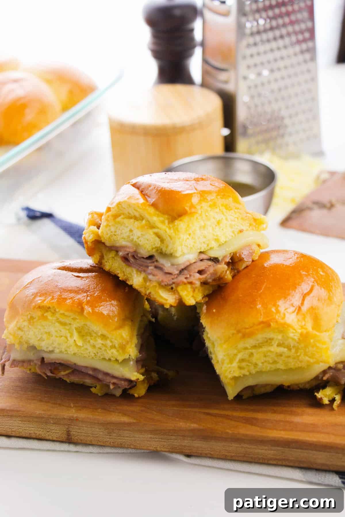 French Dip Sliders with au jus sauce for dipping.