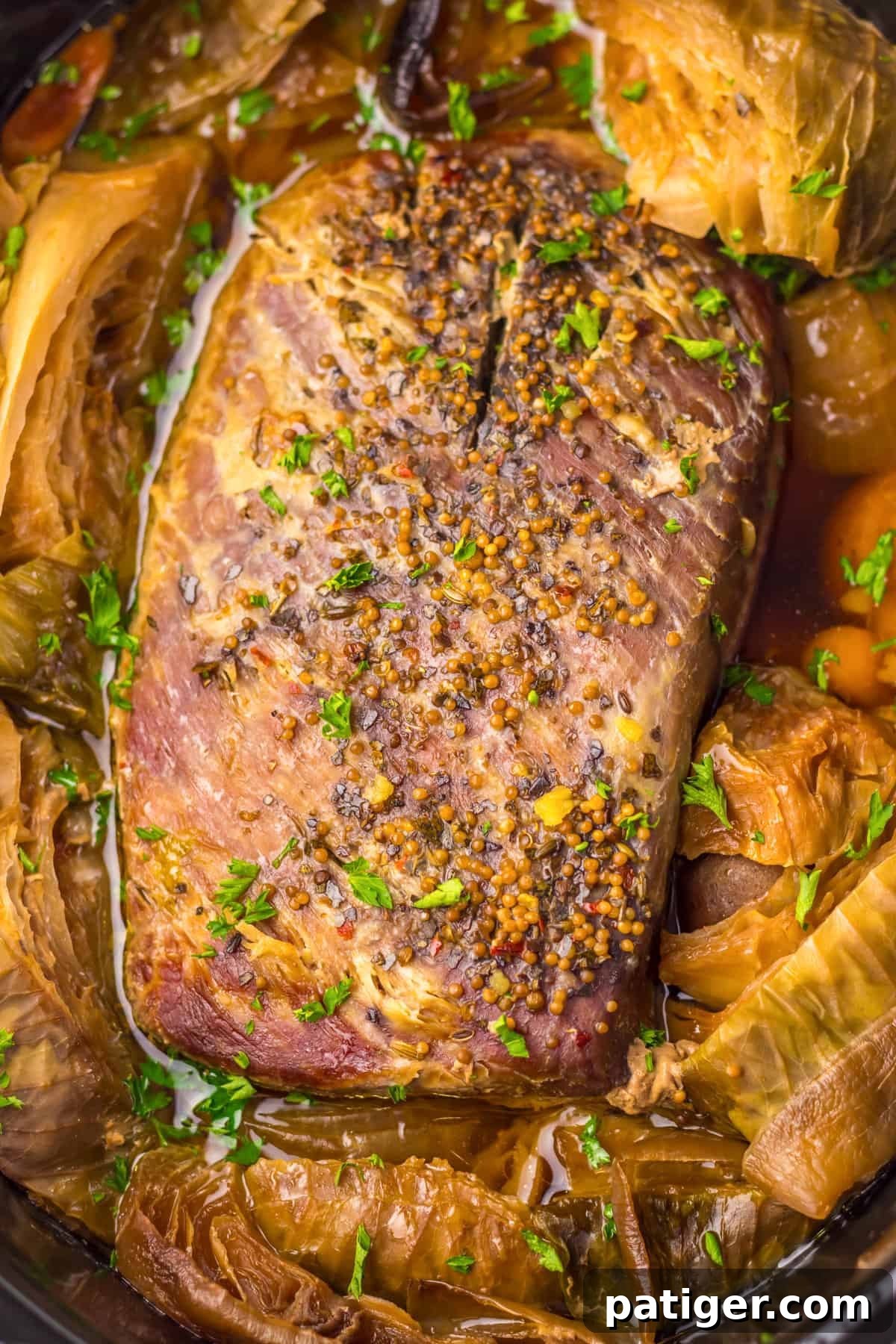 Melt-in-Your-Mouth Slow Cooker Corned Beef 5 A whole corned beef and cabbage meal beautifully arranged in a slow cooker, ready to be enjoyed.