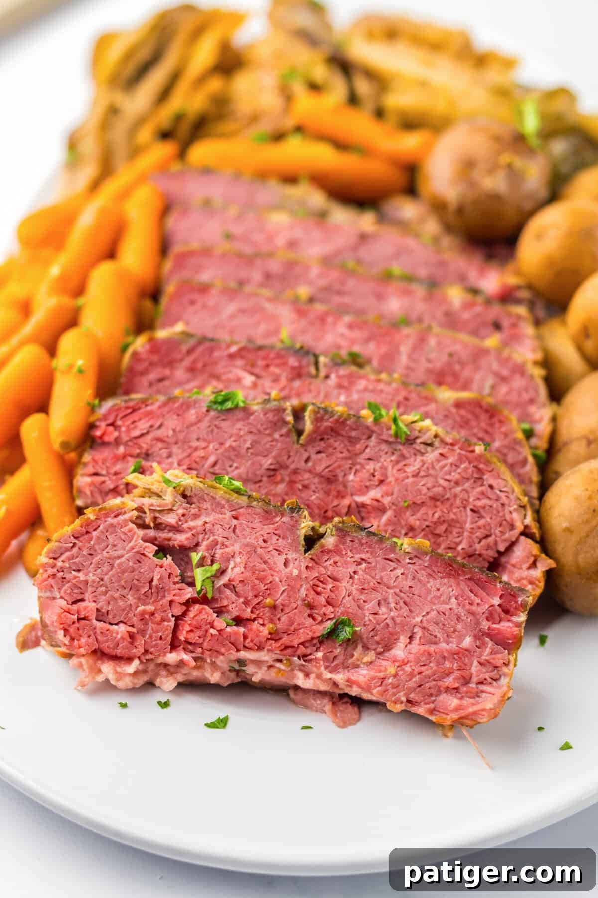 Melt-in-Your-Mouth Slow Cooker Corned Beef 6 Close-up of tender sliced corned beef served with perfectly cooked cabbage, carrots, and potatoes.
