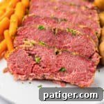 Tender and juicy crockpot corned beef brisket with baby potatoes and carrots.
