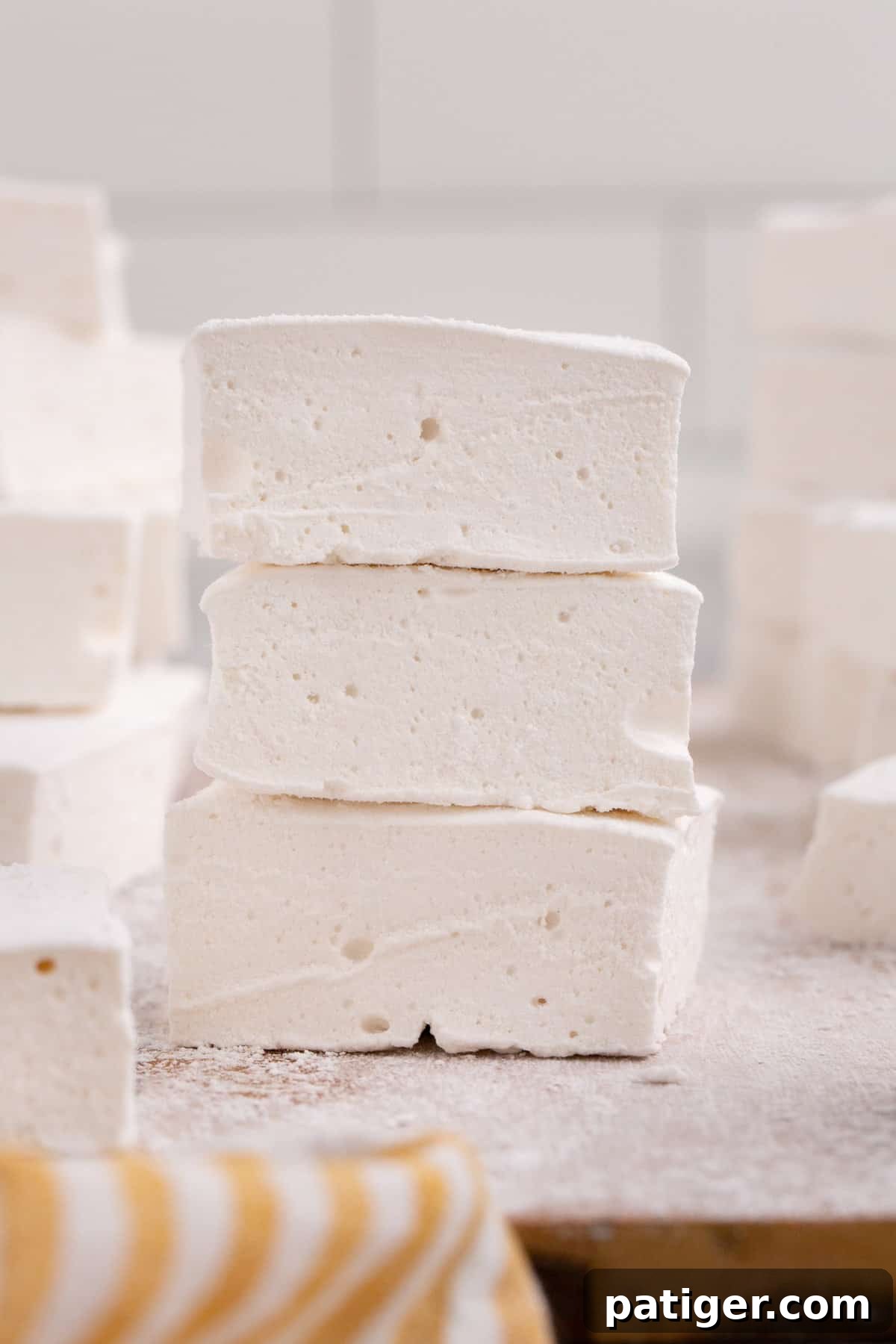 Soft and fluffy marshmallows stacked on top of one another, showing their light and airy texture.