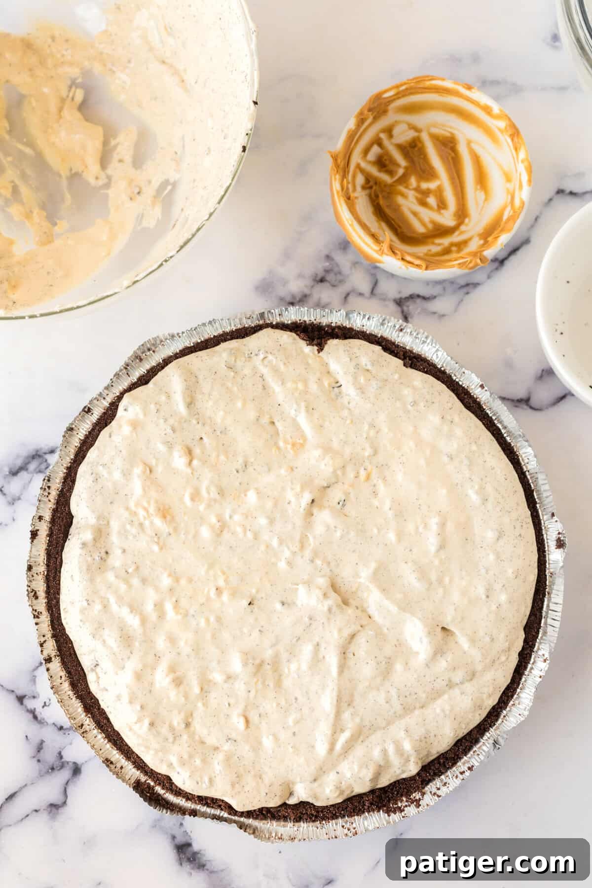 Decadent Oreo Peanut Butter Pie 7 The creamy peanut butter mousse filling has been poured into the chocolate Oreo cookie crust, ready for chilling.