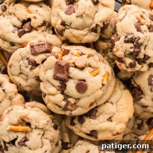 Thick Kitchen Sink Cookies with chocolate chips, peanut butter chips, pretzels, toffee bits, caramel bits, and chocolate chunks.
