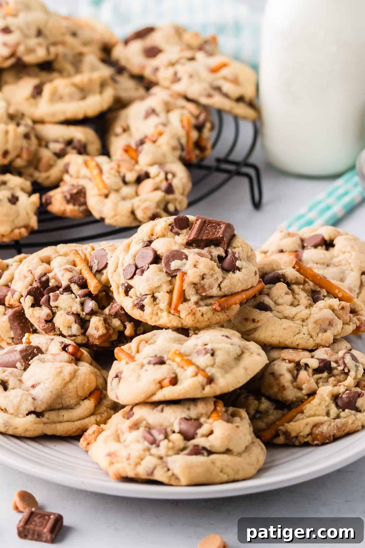 Mega Mix Cookies 3 Plate of thick and chunky kitchen sink cookies with milk in the background.