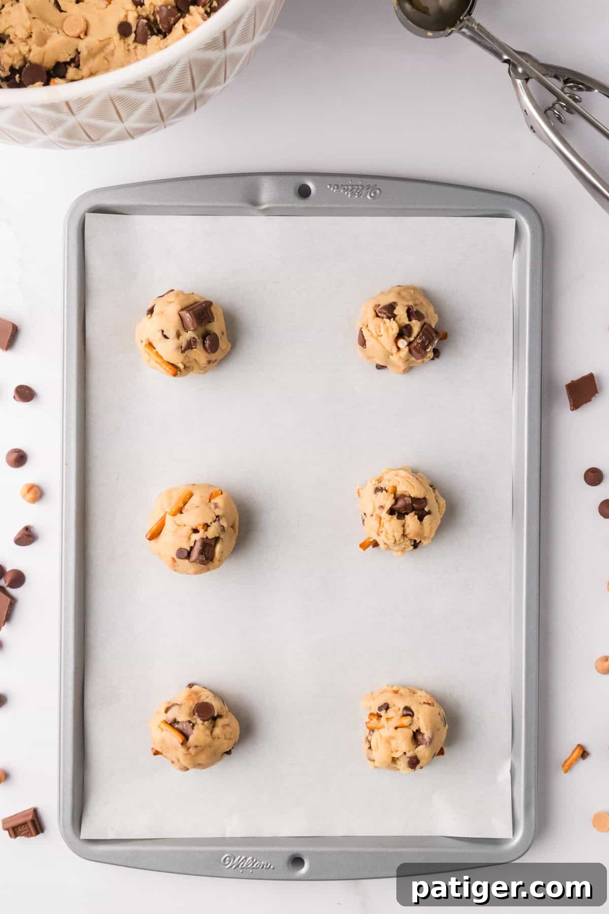 Mega Mix Cookies 8 Kitchen sink cookie dough scooped onto lined baking sheet.
